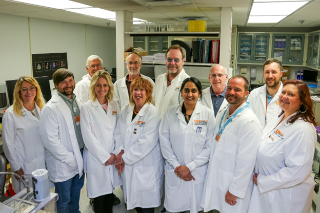 Amyloidosis and Center Theranostics Program staff pose for a picture in the lab.