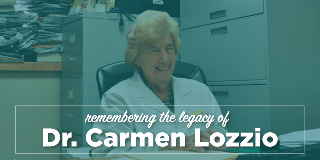 Image of smiling elderly woman. Text over the photo reads "Remembering the legacy of Dr. Carmen Lozzio".